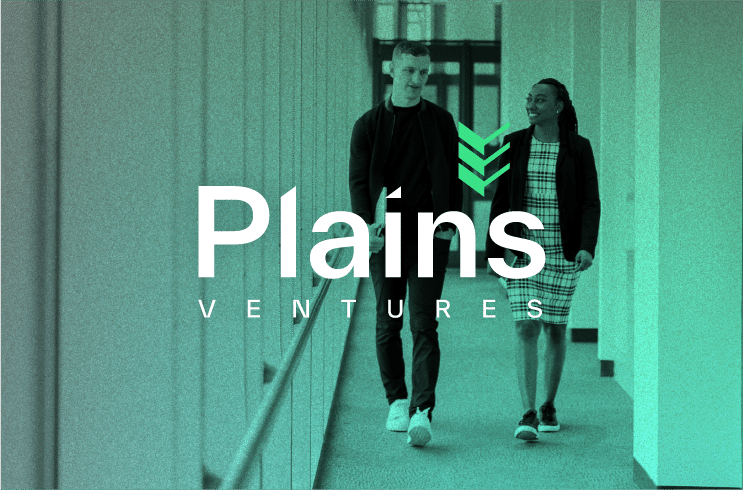Two Plains Ventures employees walking behind their company logo