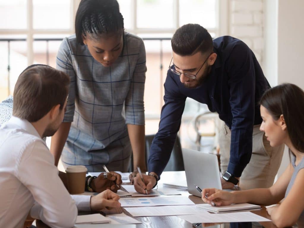 Expand-Your-Business-with-Business-Expansion-Loans-TEDC People at a table analyzing business data